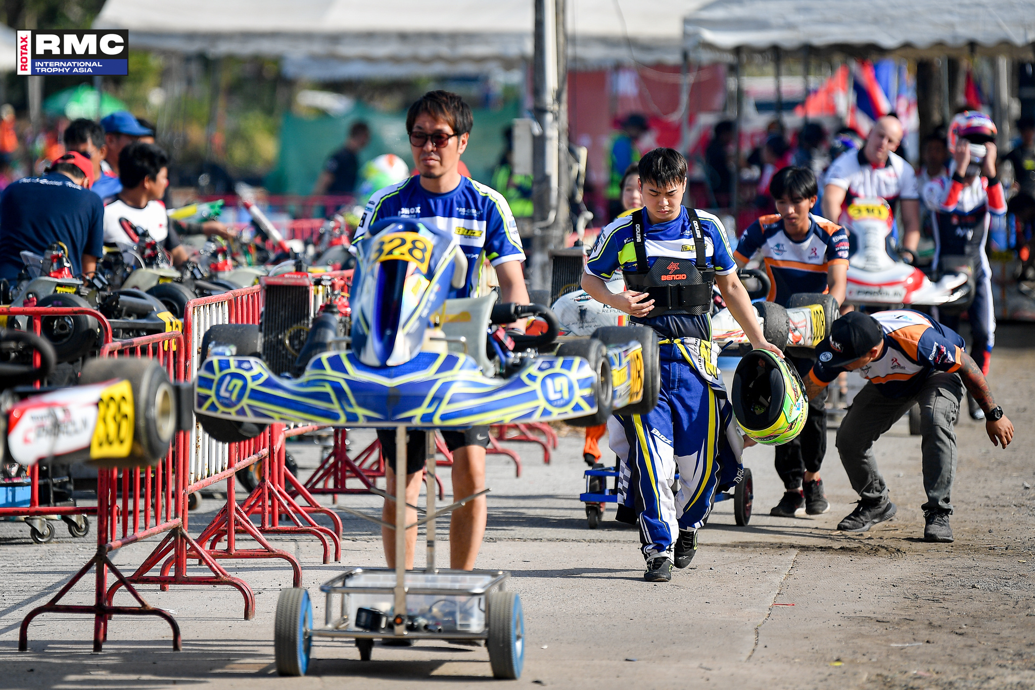 RMCIT Asia Senior MAX Drivers on their way with the Kart in the Paddock